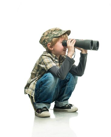 Little boy in a jeans with a binocularsの写真素材