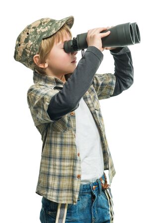 Little boy in a jeans looking through binocularsの写真素材