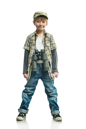 Little boy in a jeans with a binocularsの写真素材
