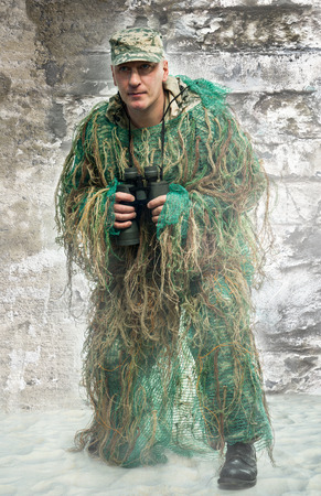 Soldier in camouflage with binocularsの写真素材