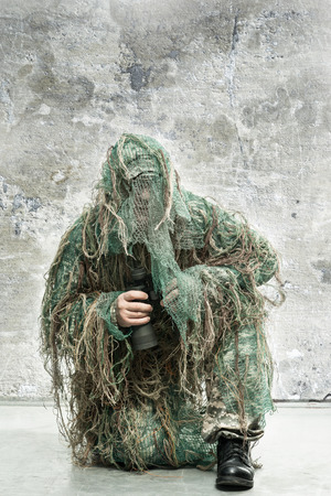 Soldier in camouflage with binocularsの写真素材