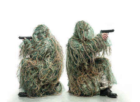 Two soldiers in camouflage with a gunsの写真素材