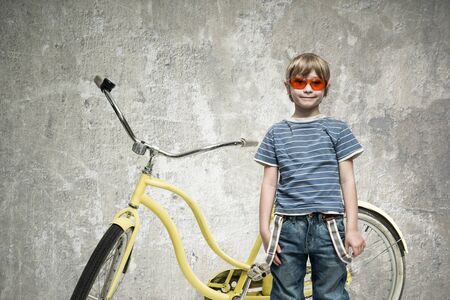 Boy with a yellow bicycleの写真素材