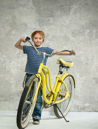 Boy with a yellow bicycleの写真素材