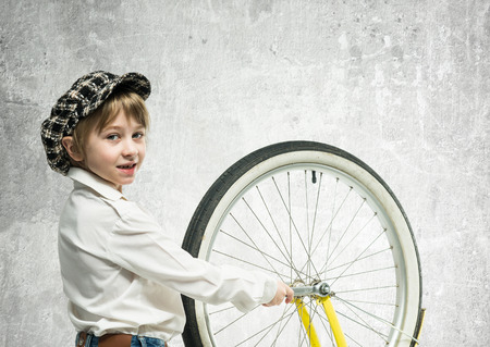 Little boy repairing a bicycleの写真素材