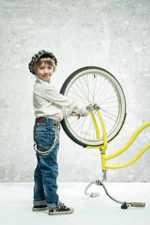 Little boy repairing a bicycleの写真素材
