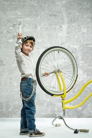 Little boy repairing a bicycleの写真素材