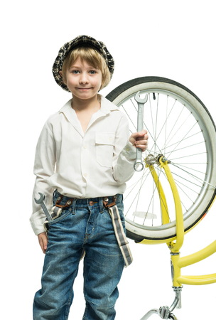 Little boy repairing a bicycleの写真素材