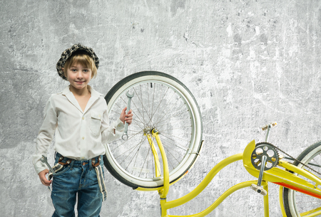 Little boy repairing a bicycleの写真素材