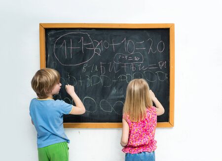 Children write on the blackboardの写真素材
