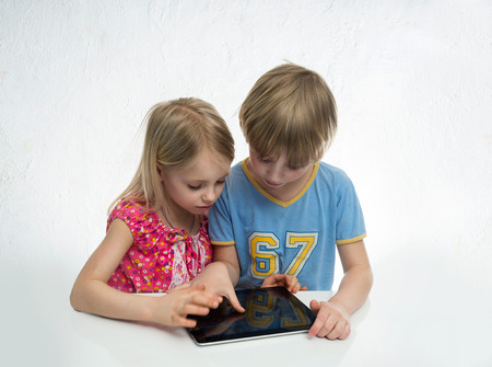 Boy and girl with clipboard computerの写真素材