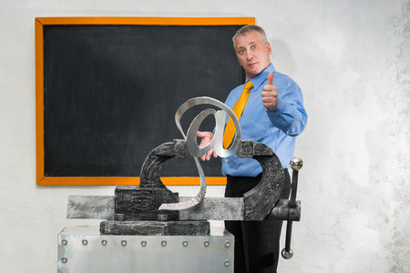 Man breaks sign of e-mail in gripの写真素材