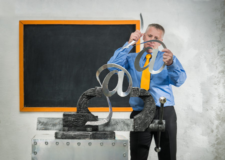 Man breaks sign of e-mail in gripの写真素材