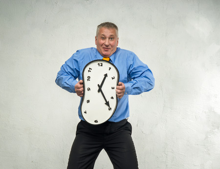 Compressed clock in the hands of manの写真素材