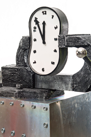 A time in a vise on a background of white wallの写真素材