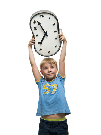 Boy holding a clock in his handsの写真素材