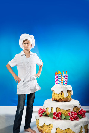 Serious confection with a birthday cakeの写真素材