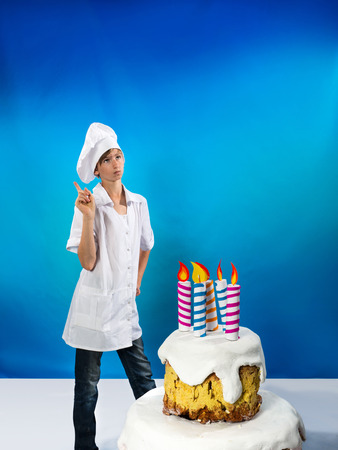 Serious confection with a birthday cakeの写真素材