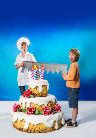 Confectioner and boy divide the birthday cakeの写真素材