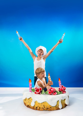 Boys set the candles on the cakeの写真素材