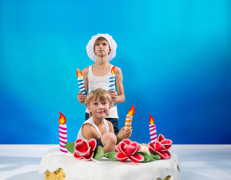 Boys set the candles on the cakeの写真素材