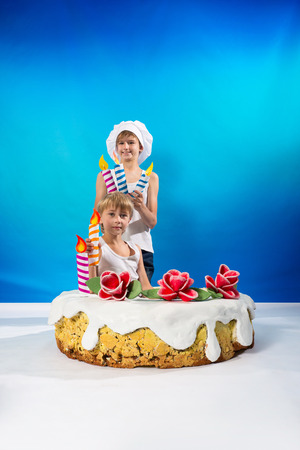 Boys set the candles on the cakeの写真素材