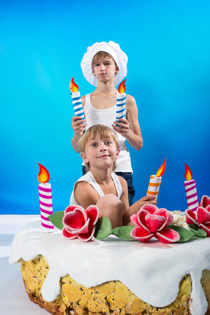 Boys set the candles on the cakeの写真素材