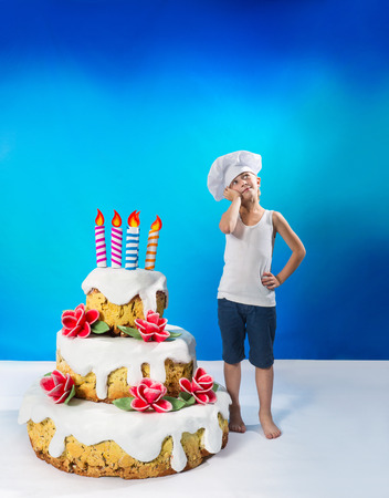 Little confectioner with a birthday cakeの写真素材