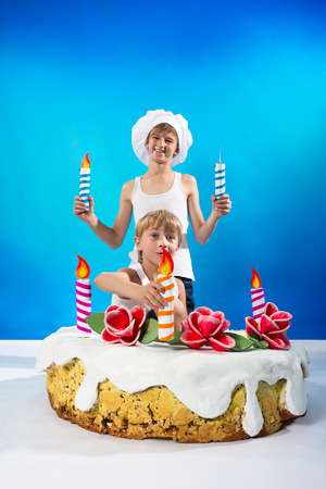 Boys set the candles on the cakeの写真素材