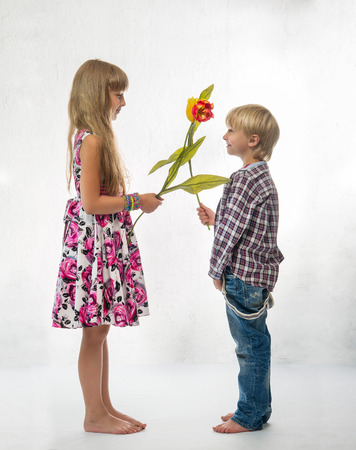 Boy and a girl with a tulipsの写真素材