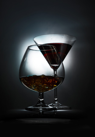 Two wineglass with the alcohol on the dark backgroundの写真素材