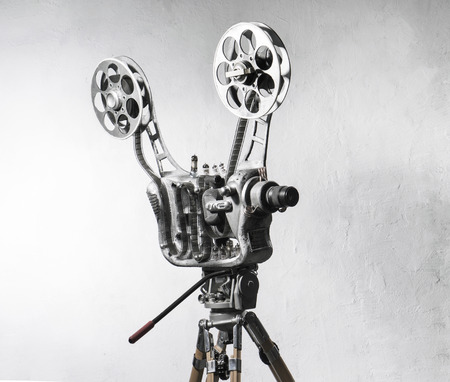 Movie projector with the film on the background of gray wallの写真素材