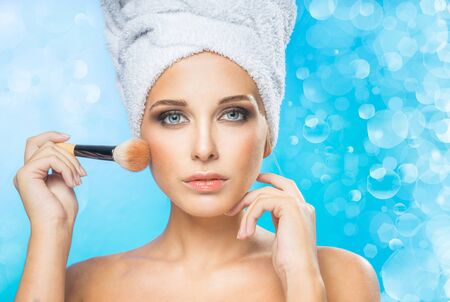 Beautiful girl powders a faceの写真素材