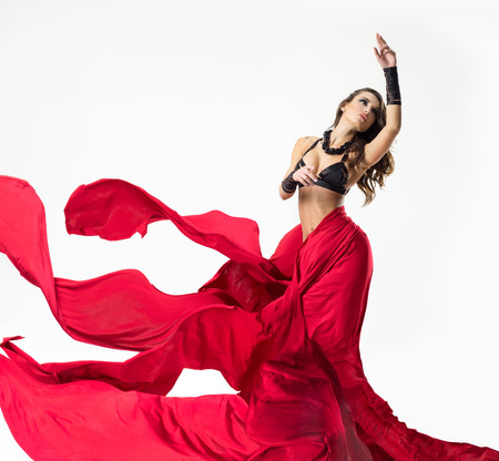 Beautiful woman in a black lingerie with a silk red fabricの写真素材