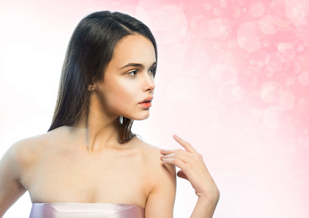 Portrait of a pretty woman on the pink backgroundの写真素材