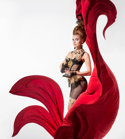 Sensual woman in a beautiful lingerie with a silk red fabricの写真素材