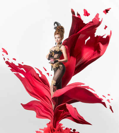 Sensual woman in a lingerie on a lacerated flower of red clothの写真素材