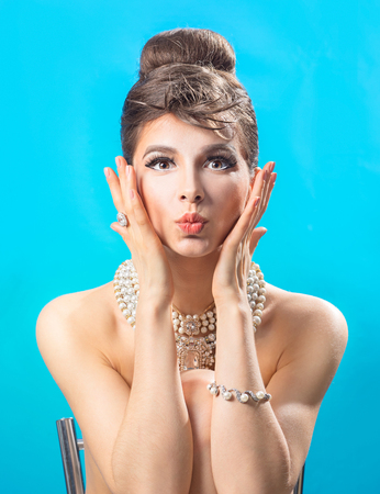 Beautiful woman with lips in a kiss on a blue backgroundの写真素材