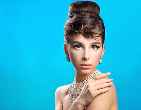 Portrait of a beautiful woman with hairstyle on a blue backgroundの写真素材