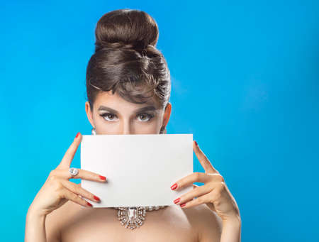Portrait of the beautiful woman with a paper in the handsの写真素材
