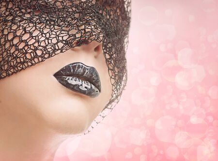 Face of girl under the black veil and makeup of lipsの写真素材