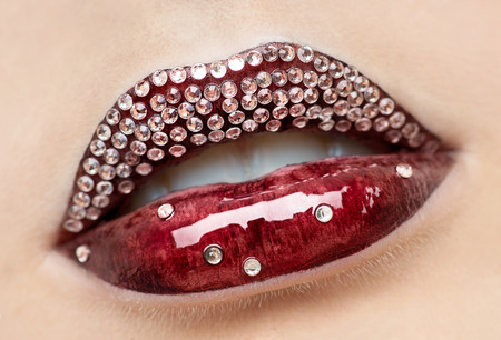 Bright female lips with red lipstick with rhinestonesの写真素材