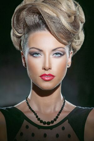 Portrait of beautiful woman with the hairstyle on the black background