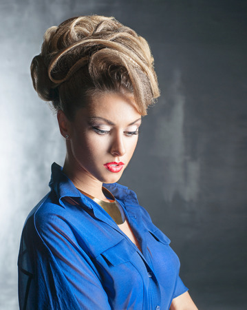 Portrait of the beautiful woman with the hairstyle and in blue blouseの写真素材