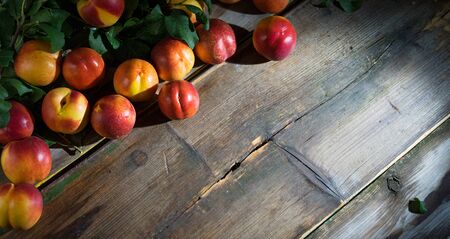 Beautiful ripe peaches on the old wooden boardsの写真素材