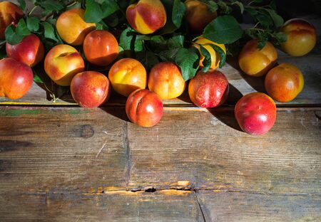 Beautiful ripe peaches on the old wooden boardsの写真素材