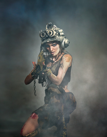 Portrait of a beautiful woman warrior in a helmet with armsの写真素材