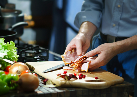 Chef with pieces of the bacon in their handsの写真素材