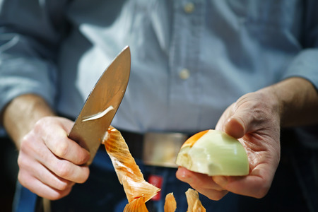 Man with the onion and with the kitchen knifeの写真素材