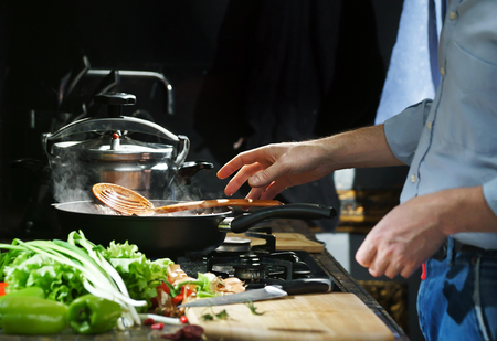 Chef prepares hotpot in the stew pan in the kitchenの写真素材